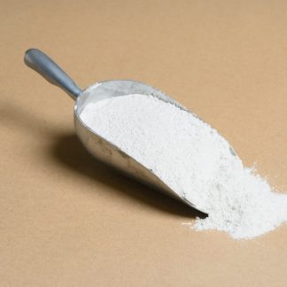 A scoop of white powder on a beige background.
