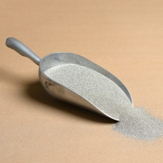 A scoop of sand on a beige background.