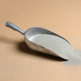 A scoop of sand on a beige background.