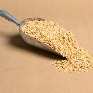 A scoop of rice on a brown surface.