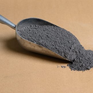 A scoop of gray Silicon-Metal powder on a brown table.