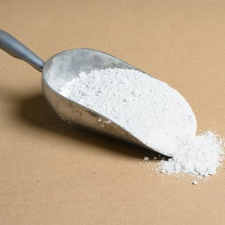 A scoop of white powder on a beige background.