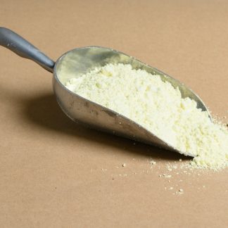 A scoop of powder on a brown surface.